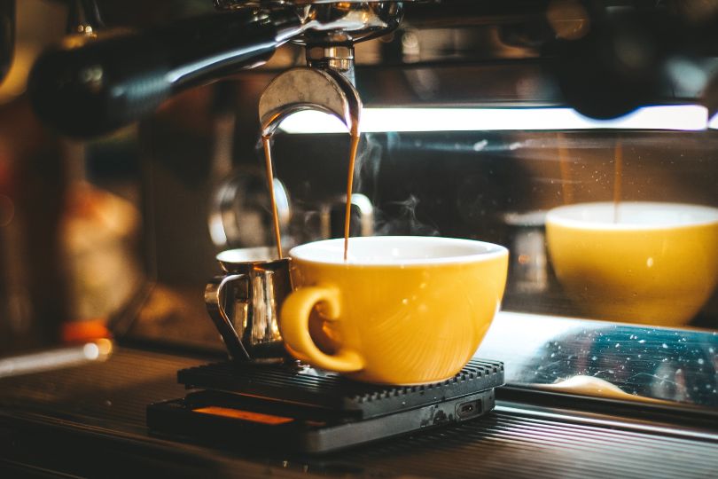 Yellow mug on coffee machine